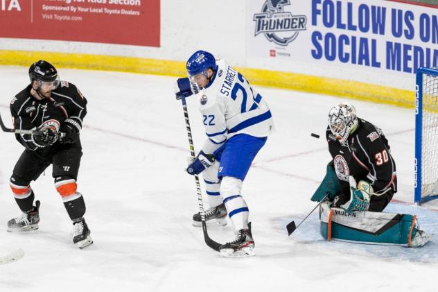 Wichita Thunder forward Beau Starrett in front of Kansas City Mavericks goaltender Andrew Shortridge