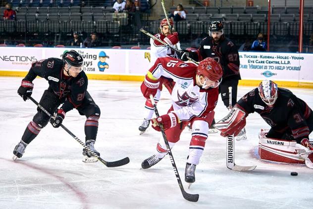 Corey Mackin of the Allen Americans (center) vs. the Rapid City Rush