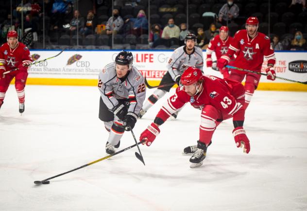 Allen Americans defenseman Matt Register (right) vies for the puck vs. the Kansas City Mavericks