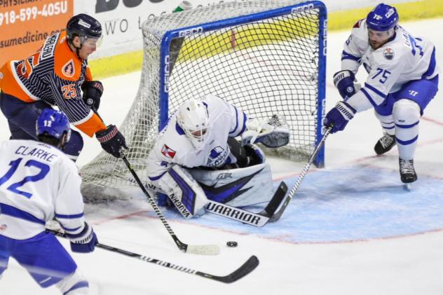 Wichita Thunder goaltender Evan Weninger eyes the puck against the Tulsa Oilers