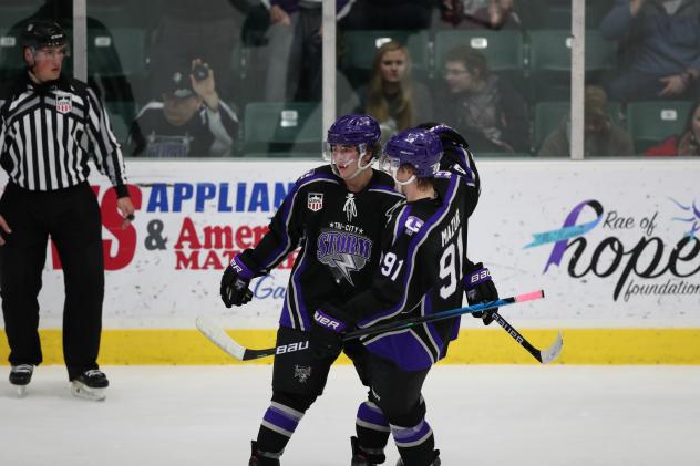 Tri-City Storm exchange congratulations after a goal