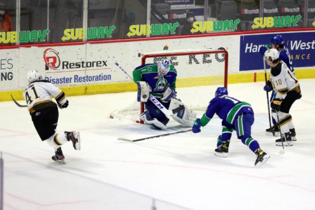 Brandon Wheat Kings defenceman Neithan Salame (left) takes a shot against the Swift Current Broncos