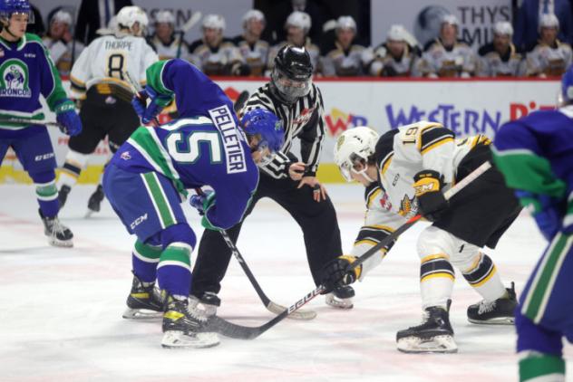 Swift Current Broncos centre Raphael Pelletier faces off with the Brandon Wheat Kings