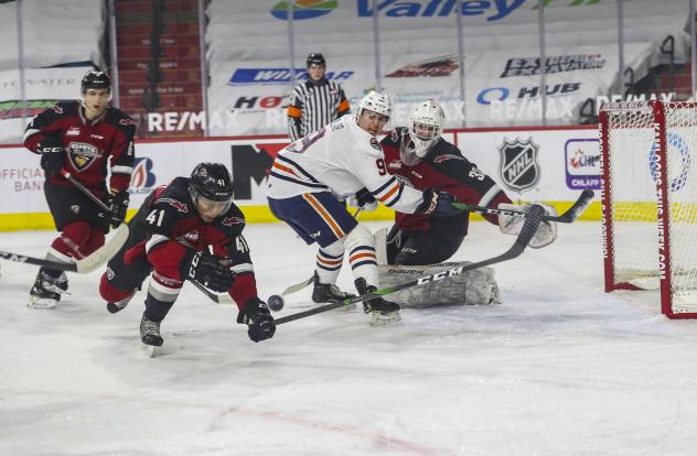 Vancouver Giants defenceman Alex Kannok Leipert tries to control a loose puck vs. the Kamloops Blazers