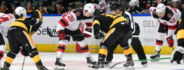 Binghamton Devils center Ryan Schmelzer (26) faces off with the Wilkes-Barre/Scranton Penguins