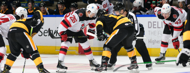 Binghamton Devils center Ryan Schmelzer (26) faces off with the Wilkes-Barre/Scranton Penguins