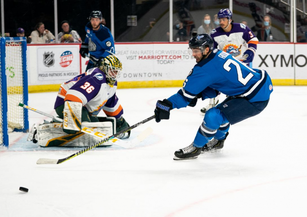 Jacksonville Icemen forward Pascal Aquin (right) reaches for a puck against the Orlando Solar Bears