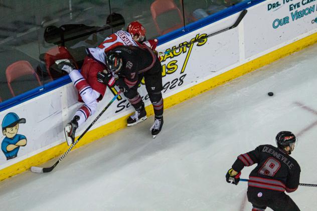 Spencer Asuchak gets checked into the boards against the Rapid City Rush