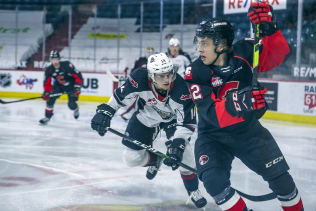 Vancouver Giants centre Eric Florchuk (left) vs. the Prince George Cougars