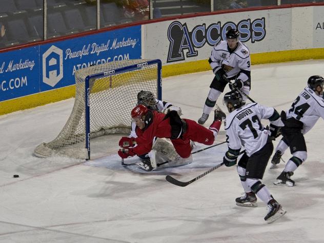 Les Lancaster of the Allen Americans barrels into the Utah Grizzlies goaltender