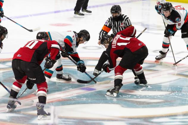 Vancouver Giants centre Eric Florchuk (right) faces off with the Kelowna Rockets