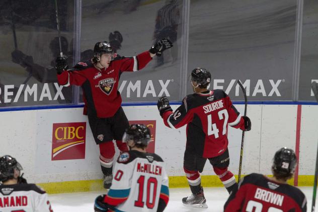 Vancouver Giants left wing Zack Ostapchuk (left) and centre Justin Sourdif celebrate a goal vs. the Kelowna Rockets