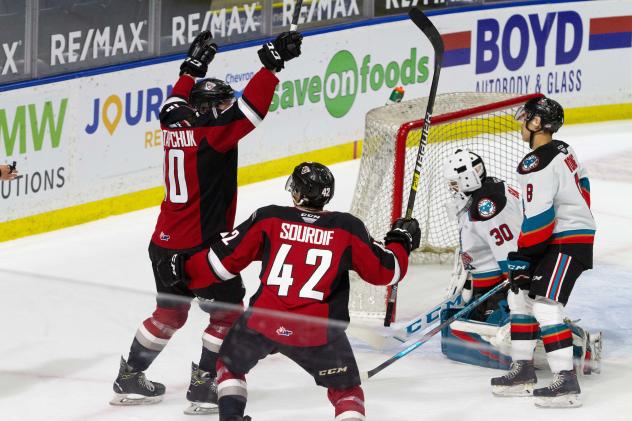 Vancouver Giants left wing Zack Ostapchuk (left) and centre Justin Sourdif react after a goal vs. the Kelowna Rockets