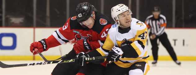 Binghamton Devils left wing Ben Thomson (left) vs. the Wilkes-Barre/Scranton Penguins