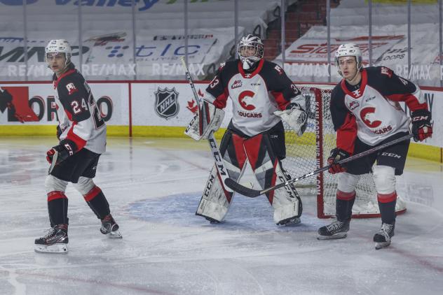 Prince George Cougars defencemen Keaton Dowhaniuk (left) and Ethan Samson flank goaltender Ty Young