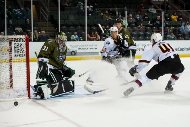 Tecas Stars goaltender Adam Scheel tips aside a shot by the Cleveland Monsters