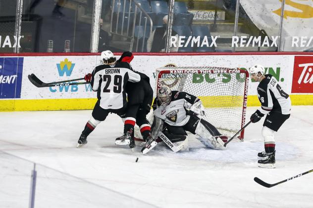 Vancouver Giants goaltender Drew Sim eyes a loose puck vs. the Prince George Cougars