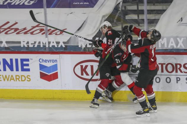 Vancouver Giants defenceman Nicco Camazzola (center) delivers a hit vs. the Prince George Cougars