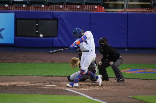 Jake Hager of the Syracuse Mets connects with a ball in the bottom of the fifth inning for a grand slam