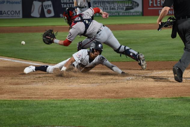 Oswaldo Cabrera of the Somerset Patriots slides home