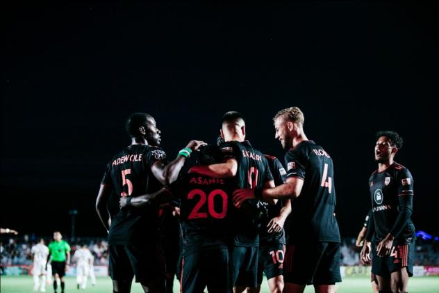 Phoenix Rising FC congratulate Solomon Asante after a goal against the Oakland Roots