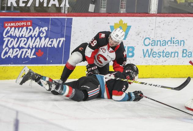 Prince George Cougars defenseman Majid Kaddoura takes down Jake Lee of the Kelowna Rockets