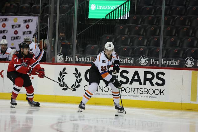 Lehigh Valley Phantoms defenseman Logan Day with the puck against the Binghamton Devils