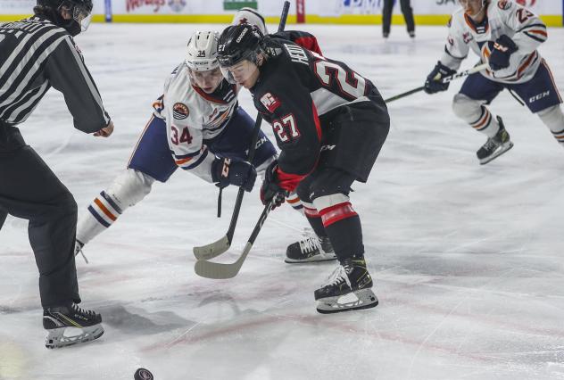 Prince George Cougars centre Riley Heidt (right) faces off with the Kamloops Blazers