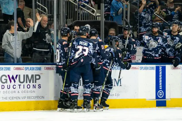 Jacksonville Icemen celebrate a goal in their Military Appreciation Weekend uniforms