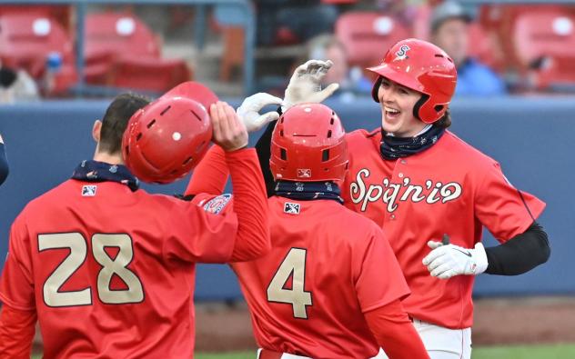 Spokane Indians exchange high fives at home plate