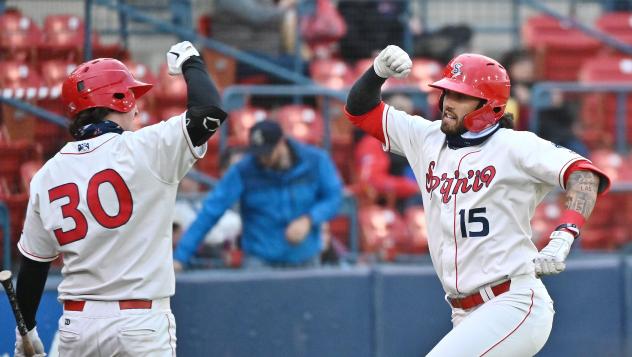 Spokane Indians outfielder Niko Decolati (right) prepares for an elbow bump from infielder Michael Toglia