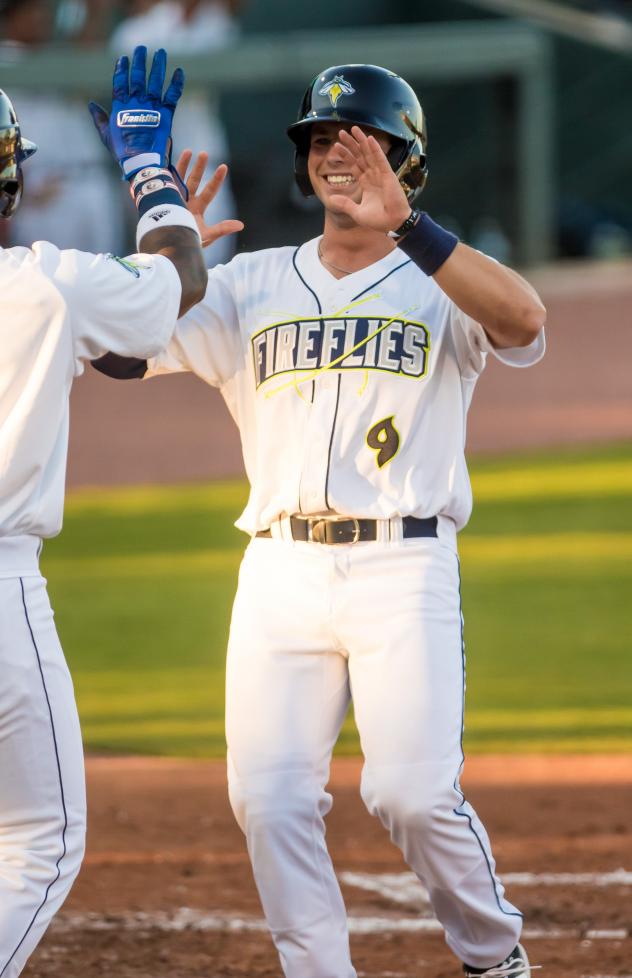 Jake Means of the Columbia Fireflies receives a greeting at home plate