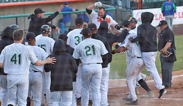 Long Island Ducks mob Lombardozzi after his walk-off grand slam
