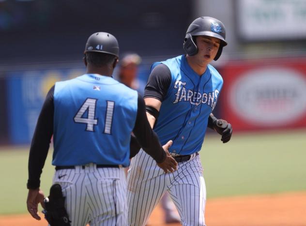 Tampa Tarpons infielder Chad Bell received congratulations from Michel Hernandez