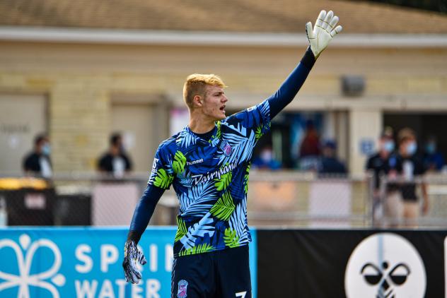 Forward Madison FC goalkeeper Chris Brady