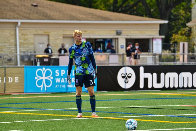 Forward Madison FC goalkeeper Chris Brady