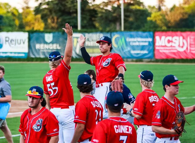 St. Cloud Rox exchange high fives between innings