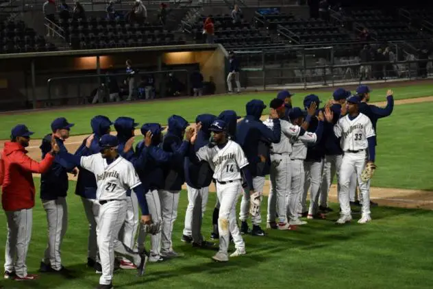 Tri-City Dust Devils exchange high fives after a win