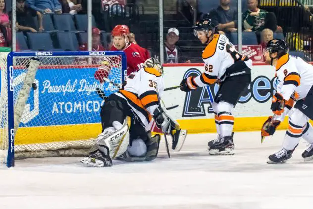 Corey Mackin of the Allen Americans (back) tucks in a goal against the Fort Wayne Komets