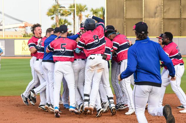 Pensacola Blue Wahoos mob J.D. Osborne after a walk-off win