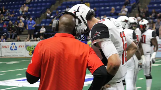 Jacksonville Sharks quarterback Connor Kaegi talks with coach James Fuller