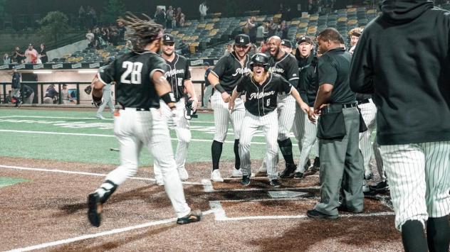 Adam Brett Walker II arrives home after his game-winning home run