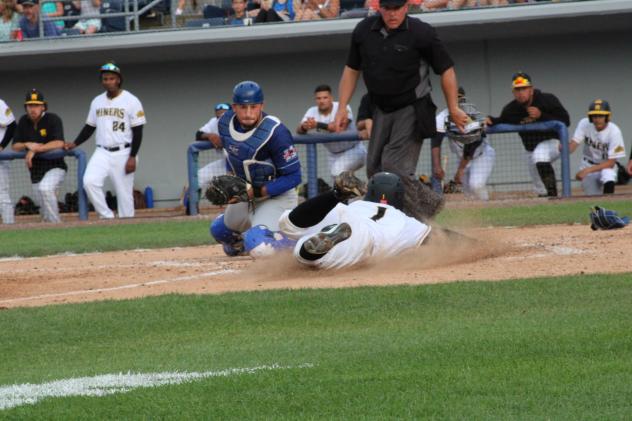Sussex County Miners outfielder Eric Jenkins slides home with a run