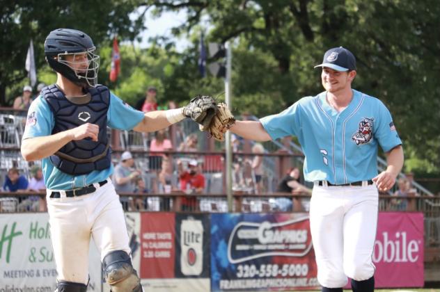 St. Cloud Rox catcher Nate Peterson bumps gloves with Caleb Ricketts
