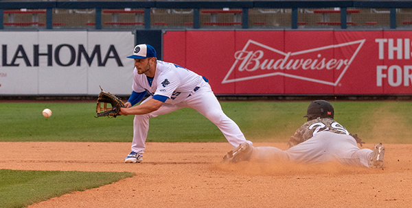 Tulsa Drillers second baseman Michael Busch tries to catch the Arkansas Travelers runner from stealing second