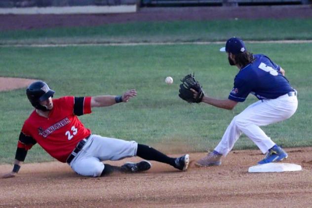 New York Boulders' Zach Penprase awaits a throw to tag out a sliding Grant Heyman of the Washington Wild Things