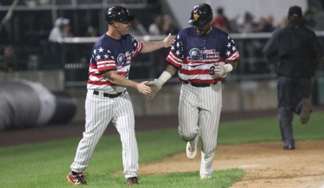 Hector Sanchez of the Long Island Ducks receives congratulations after his homer