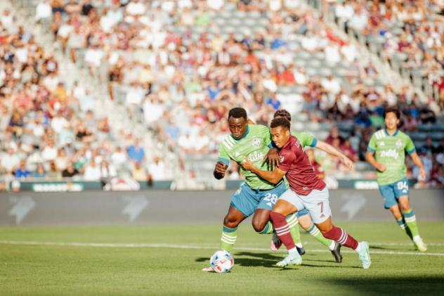 Seattle Sounders FC defender Y. Gomez Andrade (left) battles the Colorado Rapids