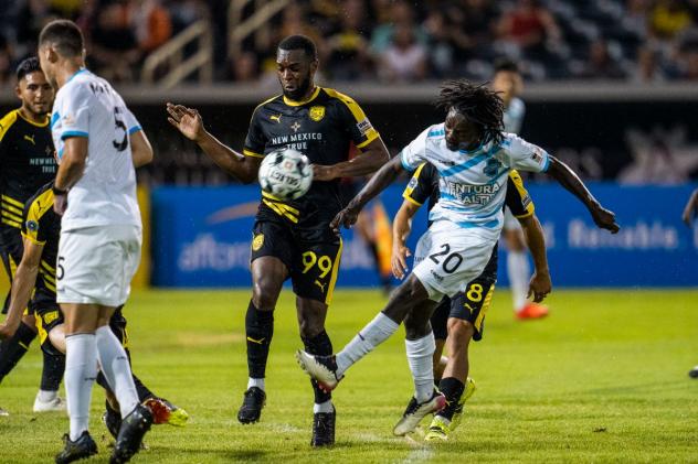 Colorado Springs Switchbacks FC midfielder Phillip Mayaka (right) vs. New Mexico United