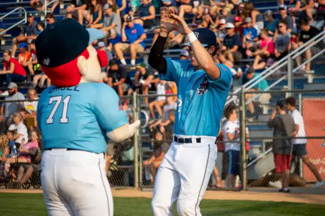 Nick Yovetich of the St. Cloud Rox high fives Chisel, the team mascot